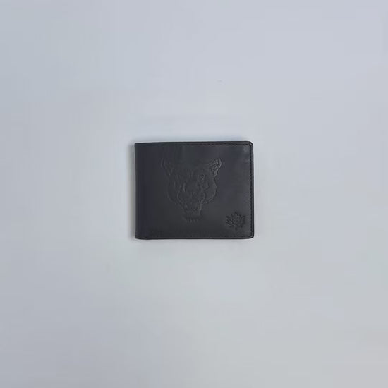 Karla Hanson Men's Mountain Lion Embossed Leather Wallet product video. Person places cash, cards, and change inside compartments in wallet.