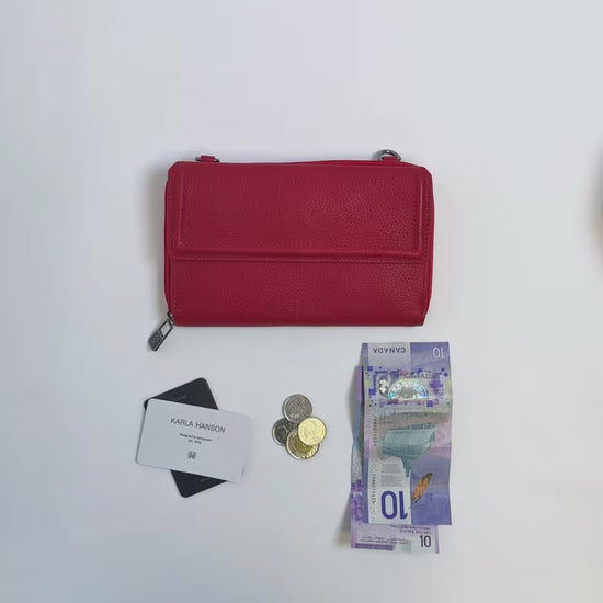 Karla Hanson women's Lorine Crossbody Wallet Leather in red product video. Person places cash, cards, and change inside compartments in wallet.