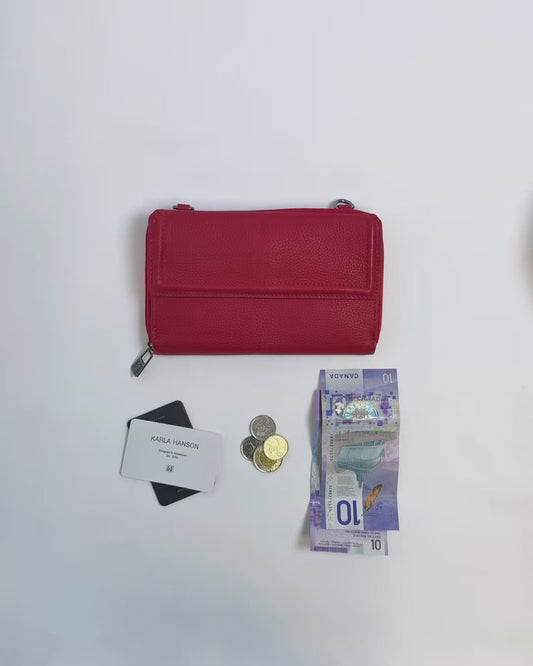 Karla Hanson women's Lorine Crossbody Wallet Leather in red product video. Person places cash, cards, and change inside compartments in wallet.