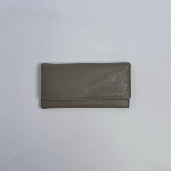 Karla Hanson Women's Trifold Wallet product video. Person places cash, cards, and change inside compartments in wallet.
