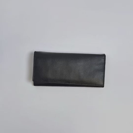 Karla Hanson Women's Bifold Leather Wallet product video. Person places cash, cards, and change inside compartments in wallet.