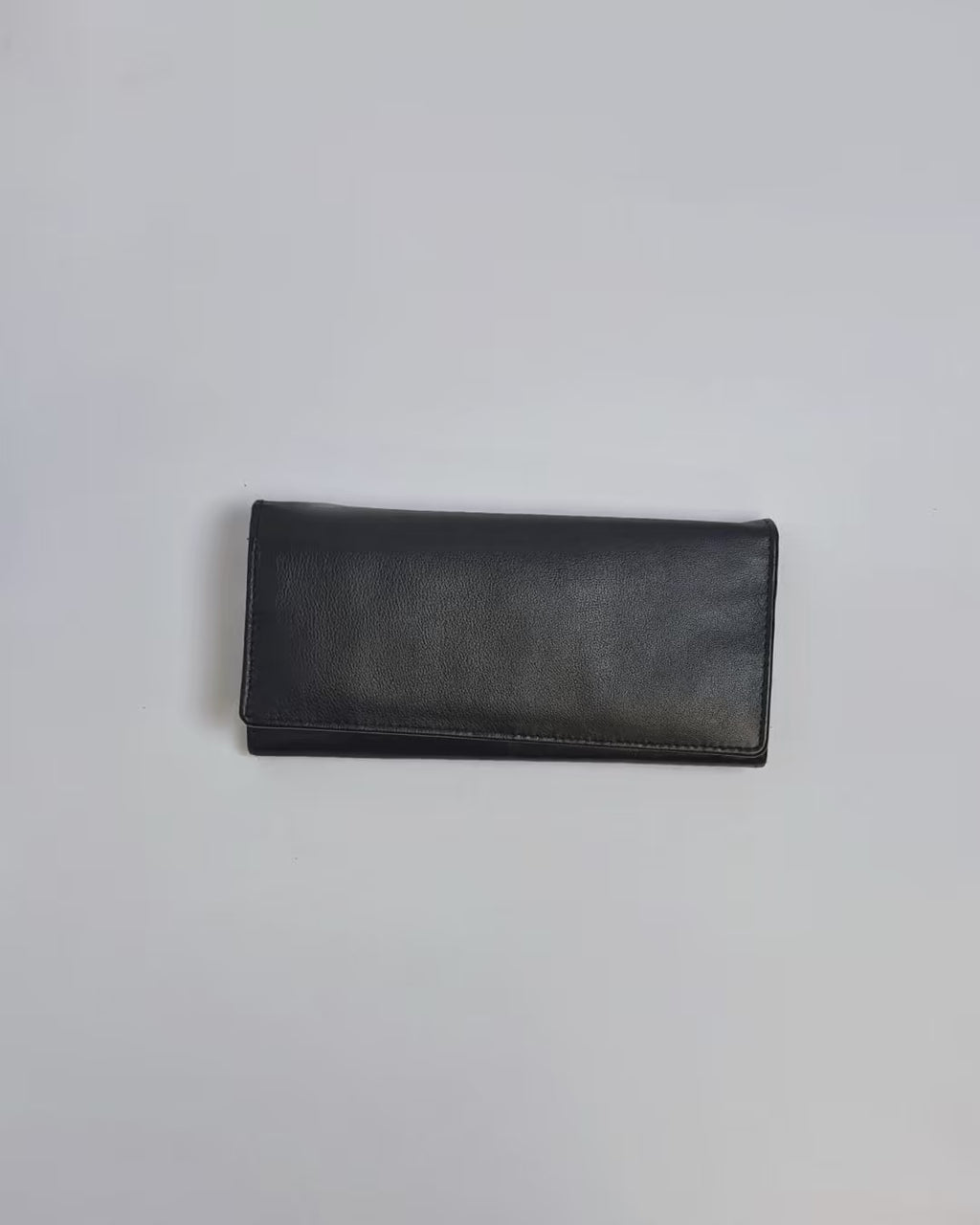 Karla Hanson Women's Bifold Leather Wallet product video. Person places cash, cards, and change inside compartments in wallet.