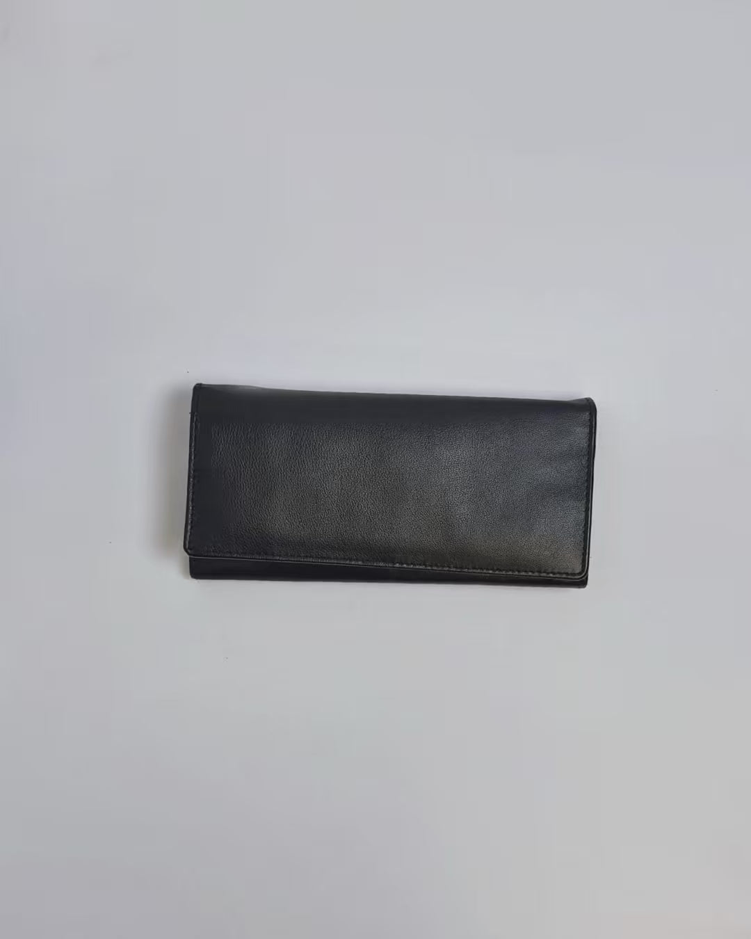 Karla Hanson Women's Bifold Leather Wallet product video. Person places cash, cards, and change inside compartments in wallet.