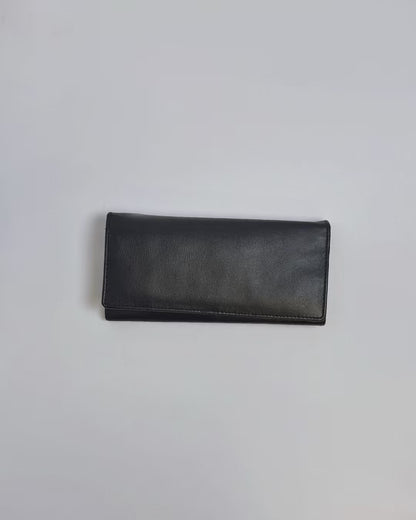 Karla Hanson Women's Bifold Leather Wallet product video. Person places cash, cards, and change inside compartments in wallet.