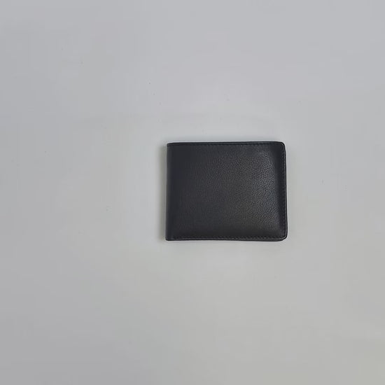 Karla Hanson Men's RFID Bifold Wallet Leather with Top Card Holder product video. Person places cash, cards, and change inside compartments in wallet.