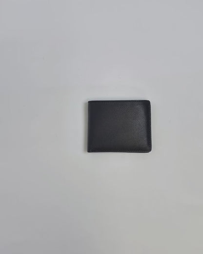 Karla Hanson Men's RFID Bifold Wallet Leather with Top Card Holder product video. Person places cash, cards, and change inside compartments in wallet.