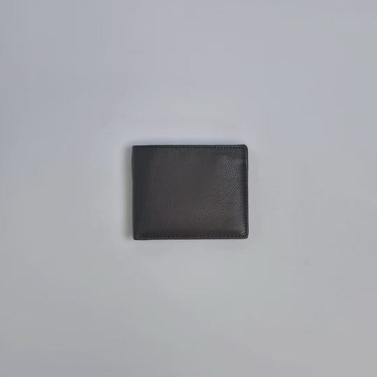 Karla Hanson Men's Leather Bifold Wallet with Coin Pocket product video. Person places cash, cards, and change inside compartments in wallet.